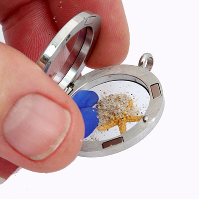 Placing the sand inside your locket