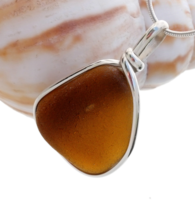 brown sea glass pendant in a silver bezel setting